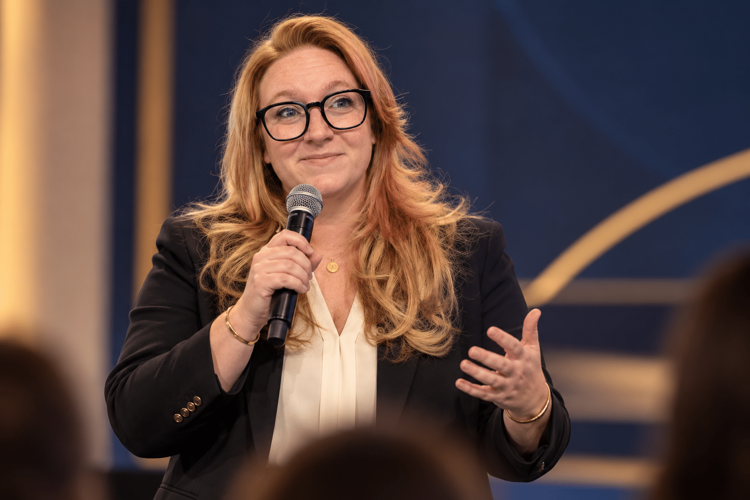 Hayley Kornilenko speaking on stage at an ERP industry event