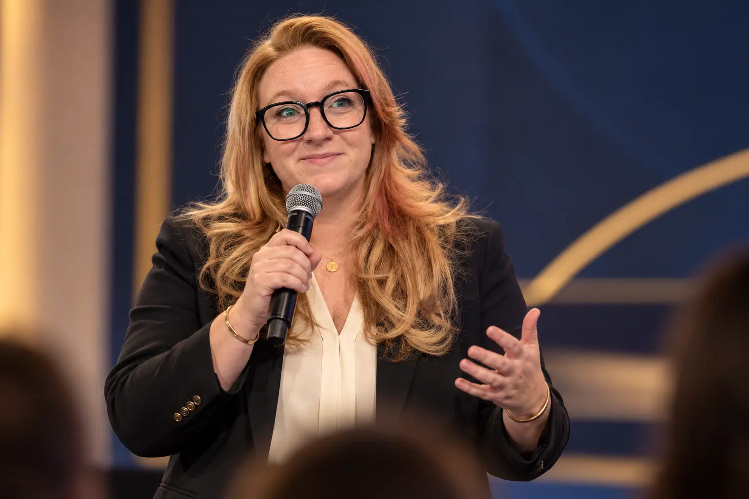 Hayley Kornilenko speaking on stage at an ERP industry event